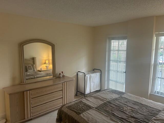 951 De Soto Road, Unit 233 Boca Raton, FL 33432 - Photo 17 of 41 a bedroom with a bed and a mirror on dresser