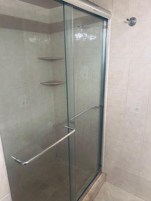 951 De Soto Road, Unit 233 Boca Raton, FL 33432 - Photo 22 of 41 a bathroom with a glass shower door