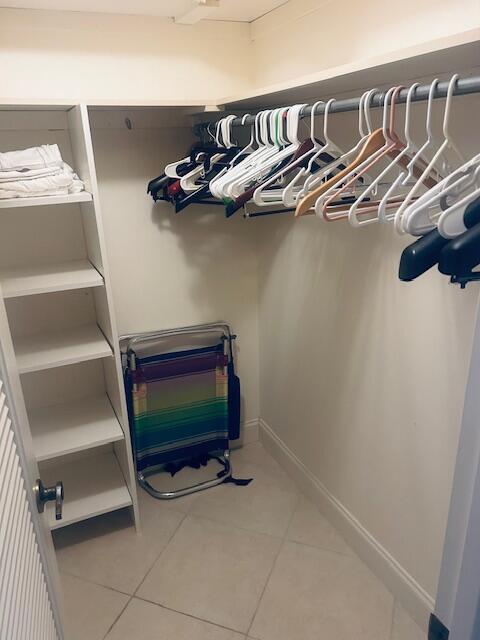 951 De Soto Road, Unit 233 Boca Raton, FL 33432 - Photo 24 of 41 a view of walk in closet with clothes and shoes