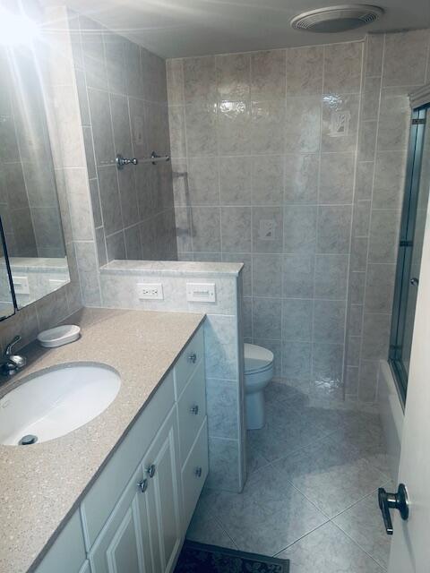 951 De Soto Road, Unit 233 Boca Raton, FL 33432 - Photo 26 of 41 a bathroom with a granite countertop sink toilet and shower