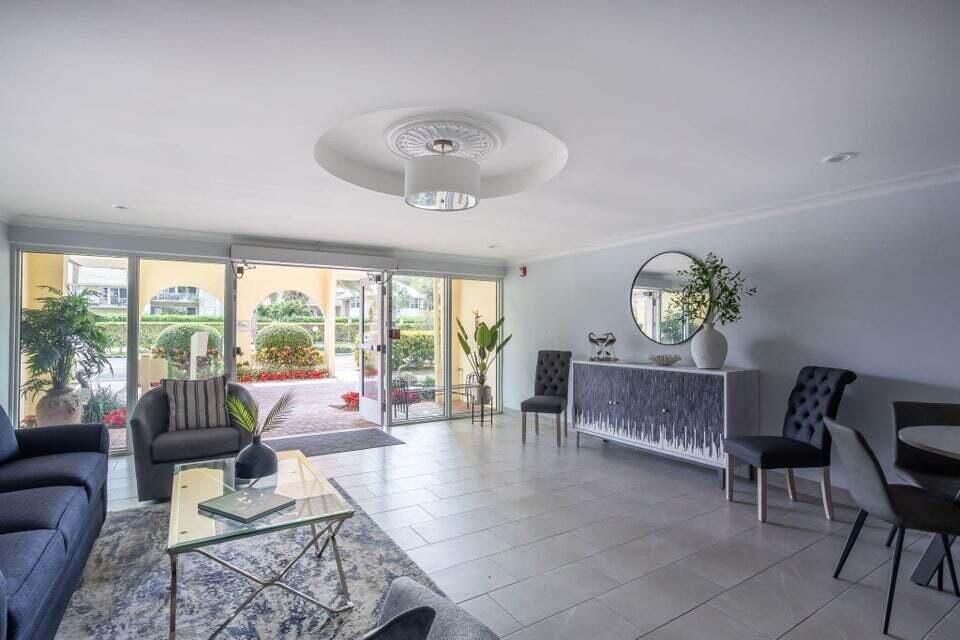 951 De Soto Road, Unit 233 Boca Raton, FL 33432 - Photo 3 of 41 a living room with furniture and a large window