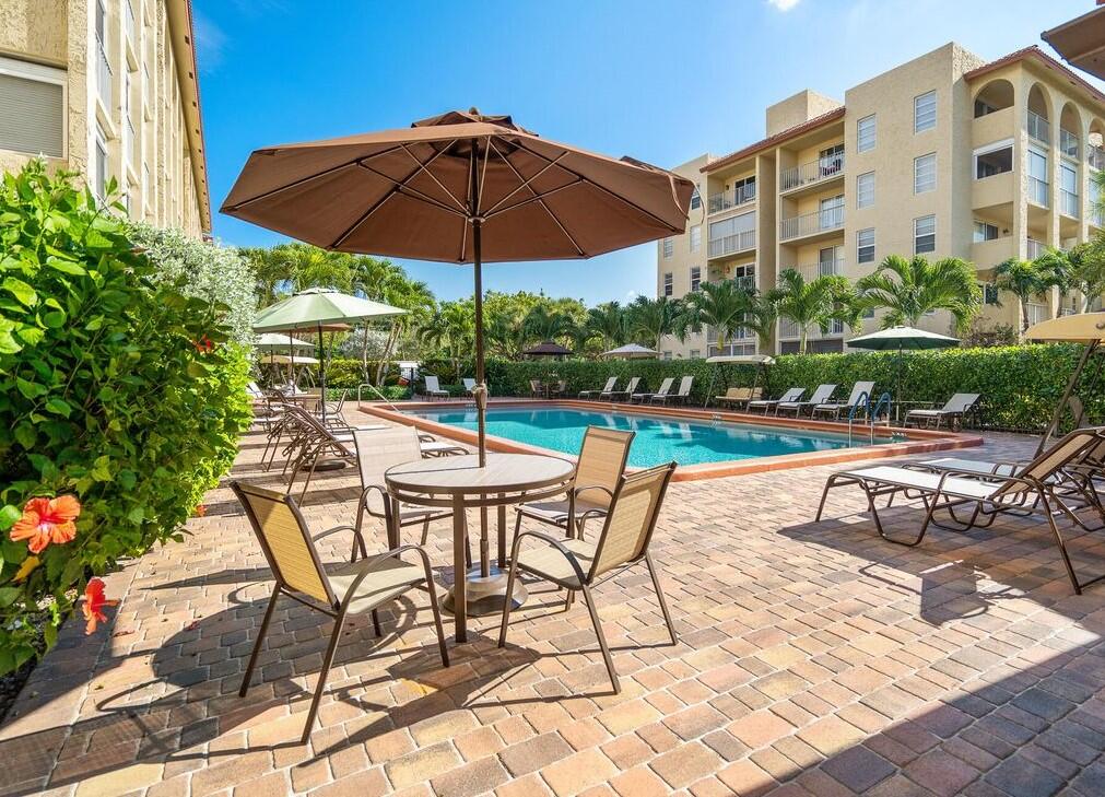 951 De Soto Road, Unit 233 Boca Raton, FL 33432 - Photo 37 of 41 a view of a swimming pool with a patio