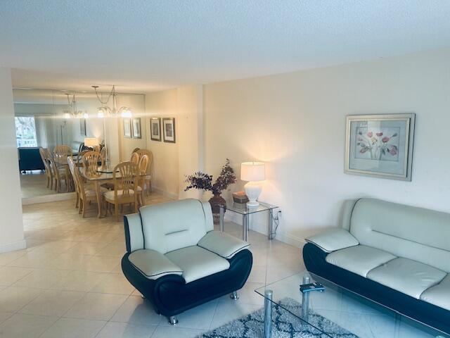 951 De Soto Road, Unit 233 Boca Raton, FL 33432 - Photo 4 of 41 a living room with furniture and a chandelier