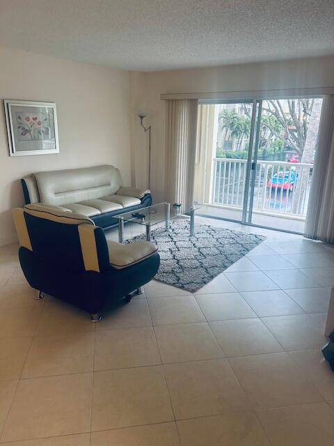 951 De Soto Road, Unit 233 Boca Raton, FL 33432 - Photo 5 of 41 a room with a bed and a large window