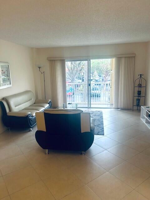 951 De Soto Road, Unit 233 Boca Raton, FL 33432 - Photo 6 of 41 a living room with furniture and a large window