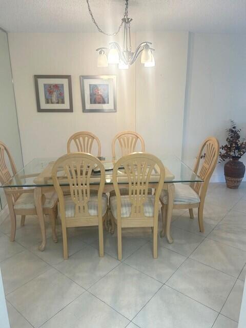 951 De Soto Road, Unit 233 Boca Raton, FL 33432 - Photo 7 of 41 a view of a dining room with furniture and chandelier