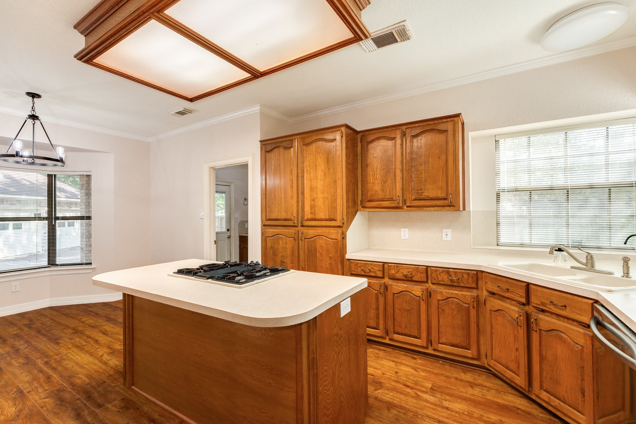1600 Azalea Street Sweeny, TX 77480 - Photo 23 of 42 a kitchen with a sink and wooden cabinets