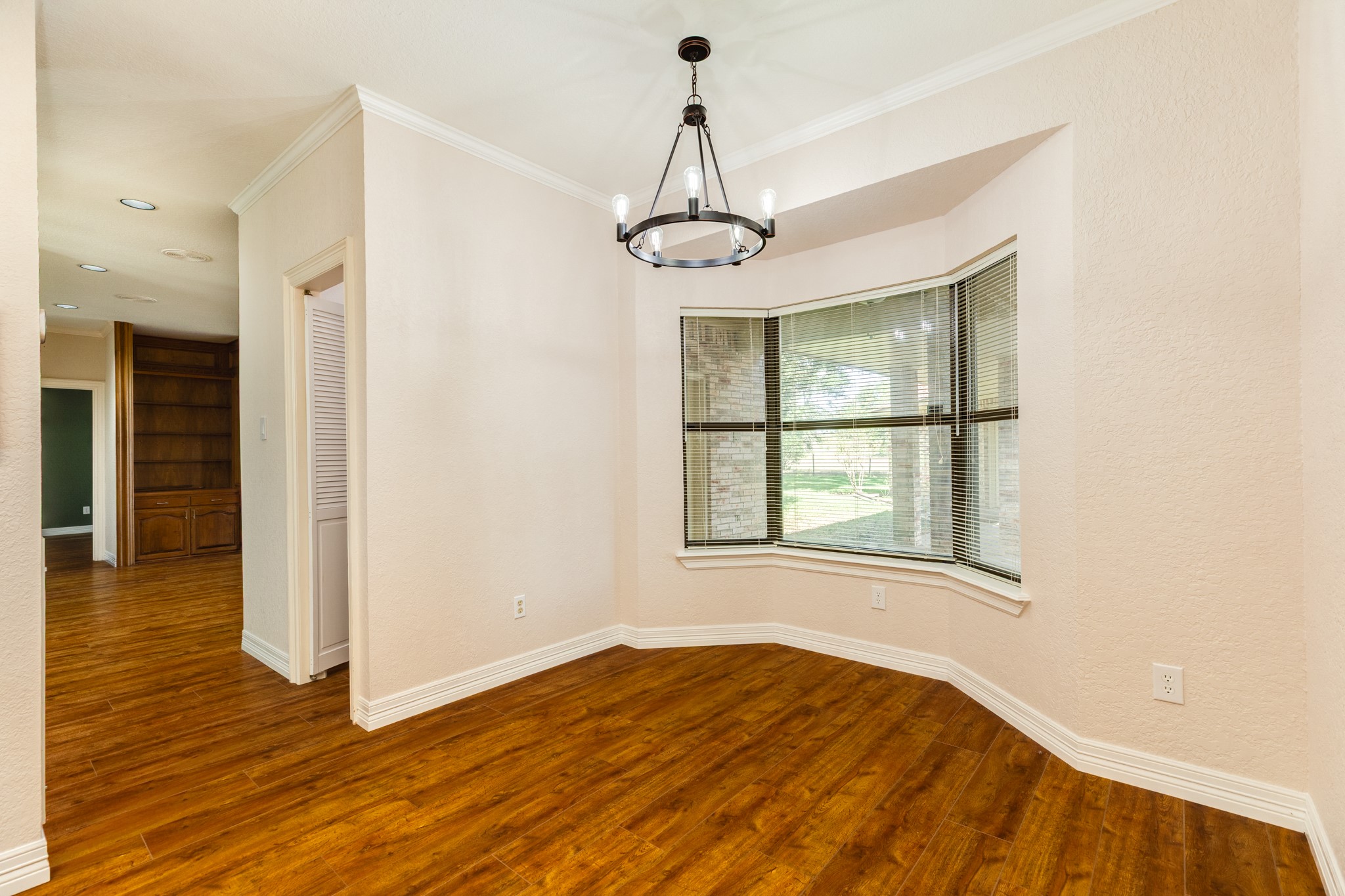 1600 Azalea Street Sweeny, TX 77480 - Photo 25 of 42 a view of an empty room with wooden floor and a window