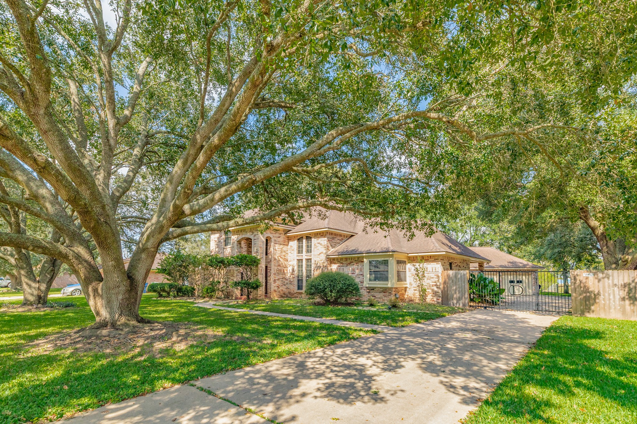 1600 Azalea Street Sweeny, TX 77480 - Photo 3 of 42 a front view of a house with a garden