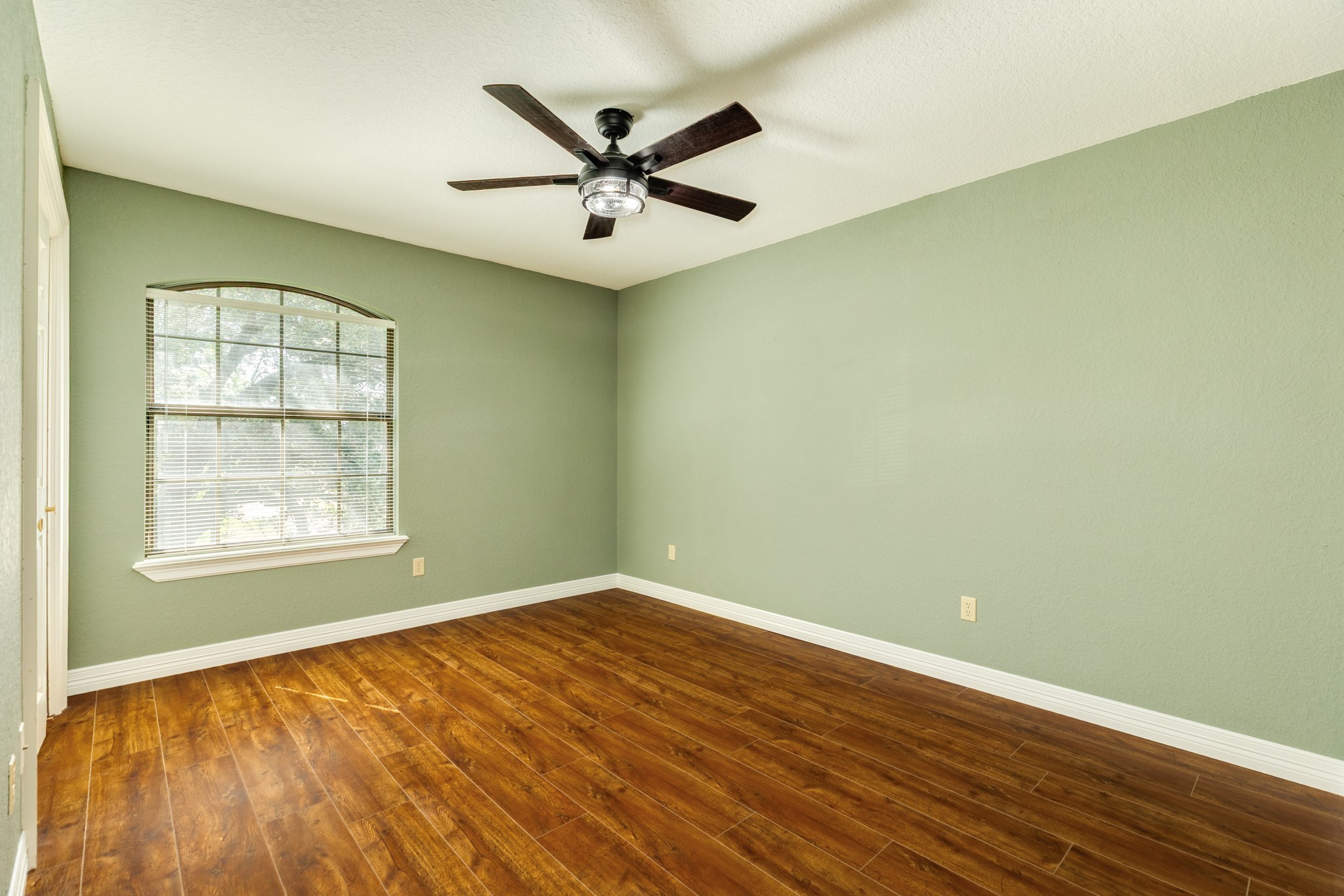 1600 Azalea Street Sweeny, TX 77480 - Photo 38 of 42 an empty room with wooden floor and windows