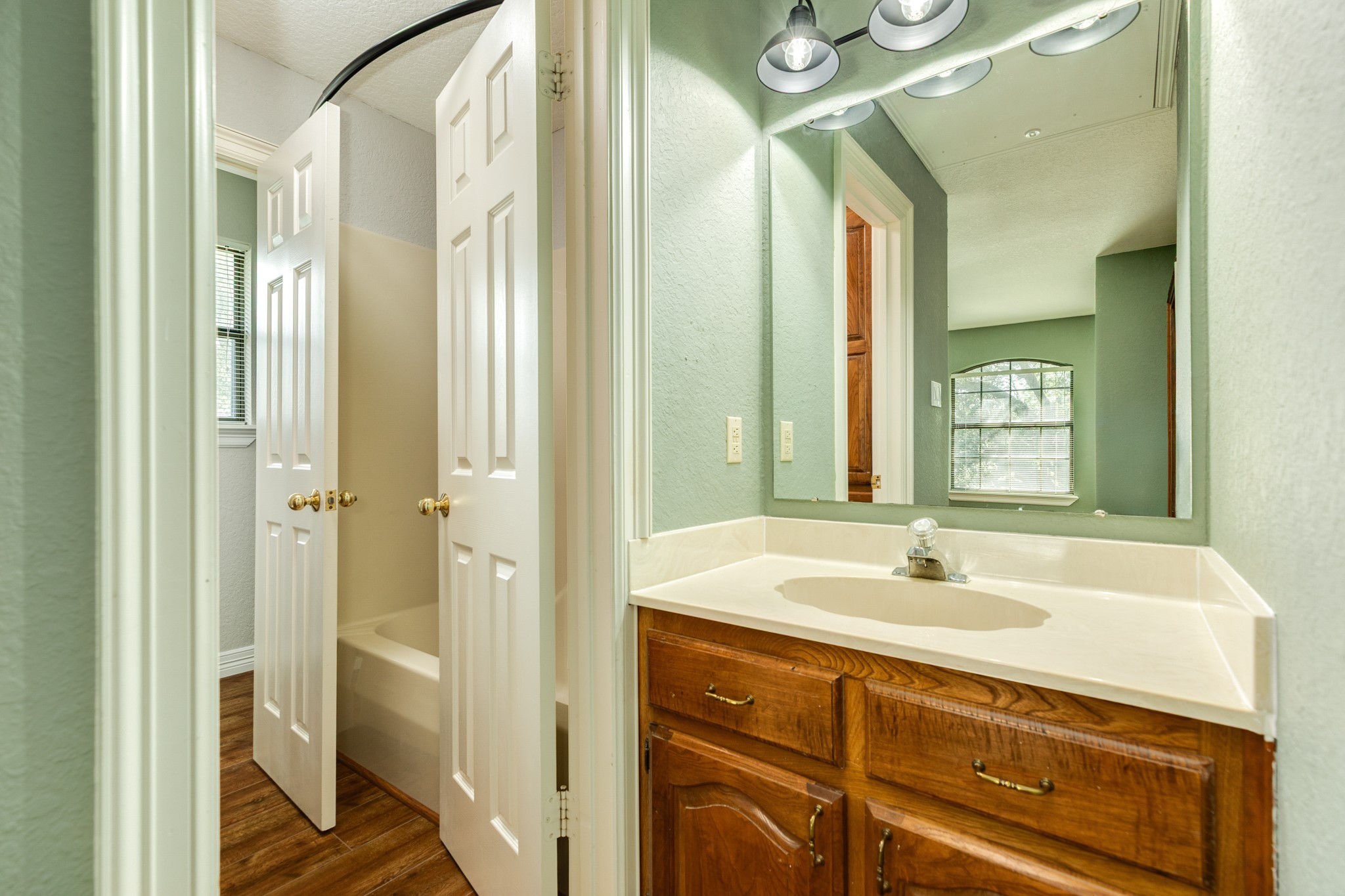 1600 Azalea Street Sweeny, TX 77480 - Photo 39 of 42 a bathroom with a sink and a mirror