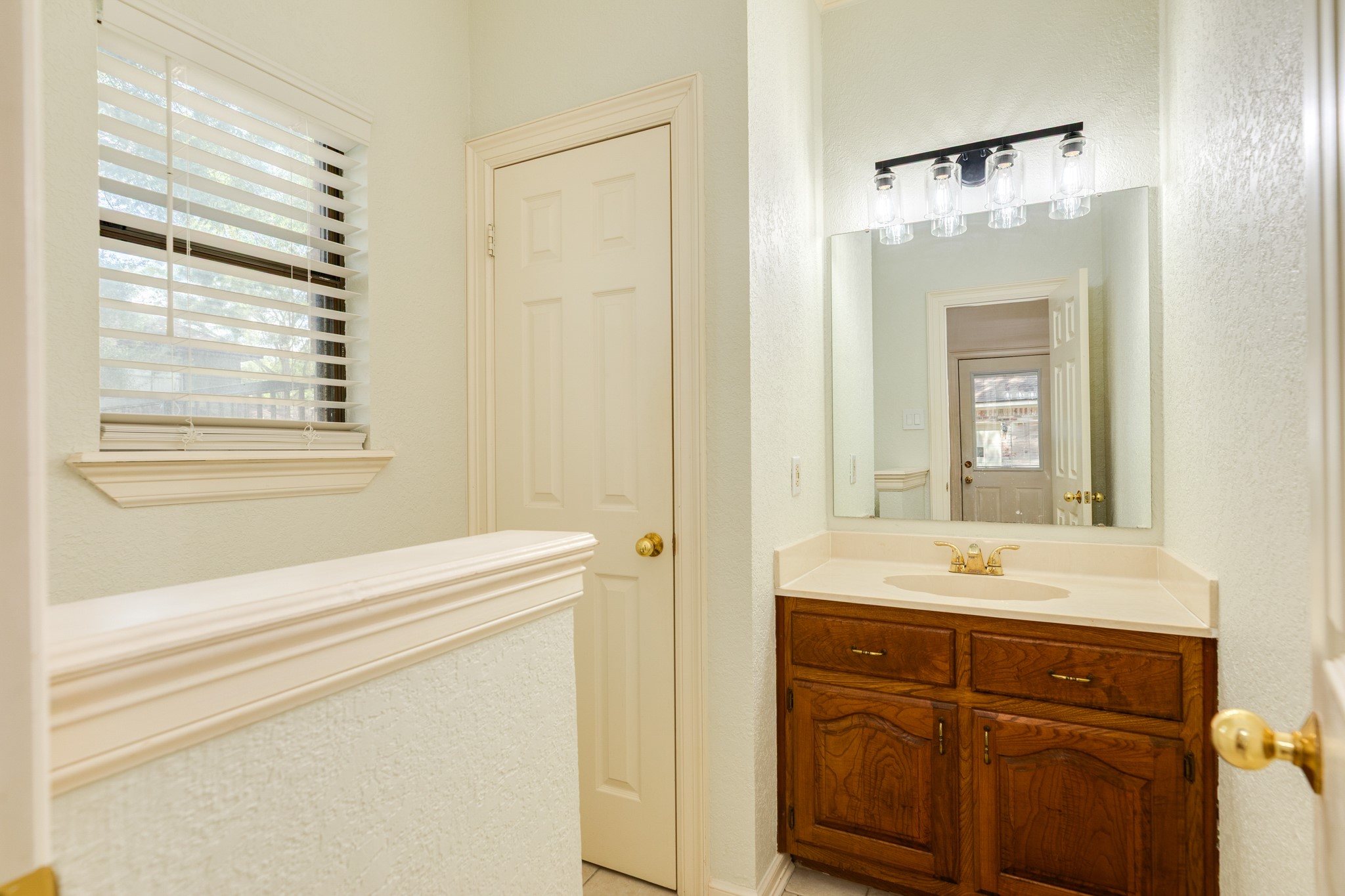 1600 Azalea Street Sweeny, TX 77480 - Photo 40 of 42 a bathroom with a sink a vanity and a mirror