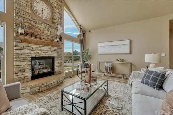 a living room with furniture a fireplace and a table
