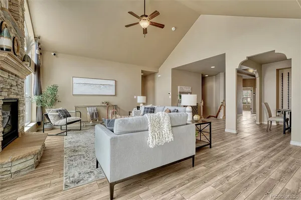 a living room with furniture dining table and a fireplace