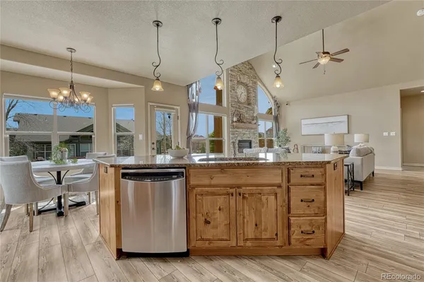 a kitchen with a sink appliances and wooden floor