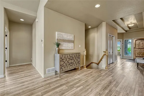 a view of a hallway with wooden floor