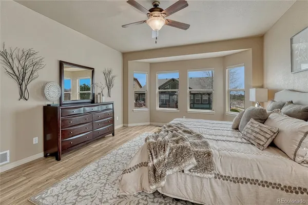 a bedroom with a bed and a large window