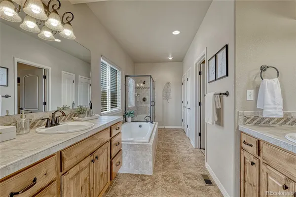 a spacious bathroom with a double vanity sink shower and a mirror
