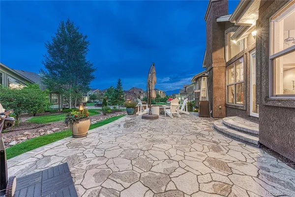 a view of a backyard with sitting area