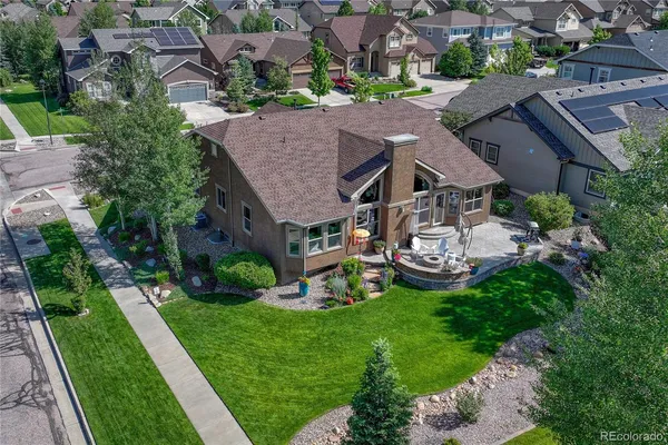 an aerial view of a house with a garden and swimming pool