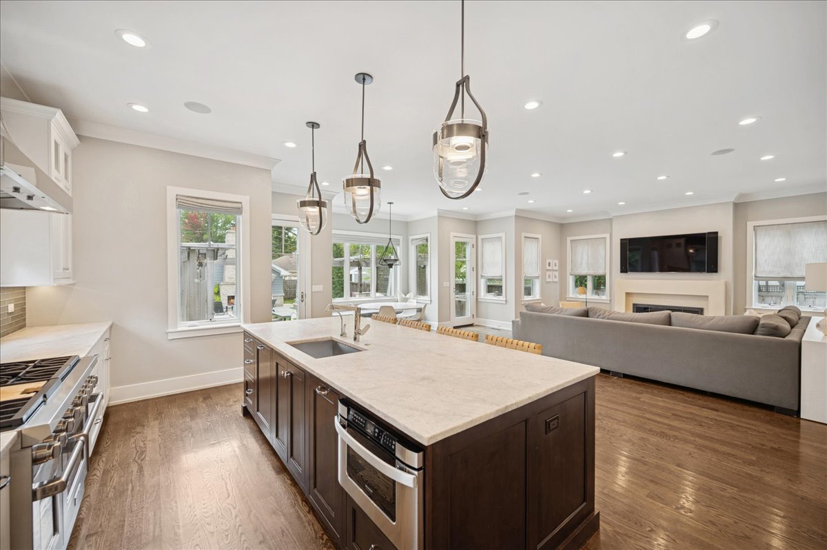 1004 Oak Street Winnetka, IL 60093 - Photo 16 of 51 a large kitchen with stainless steel appliances lots of counter space and wooden floor