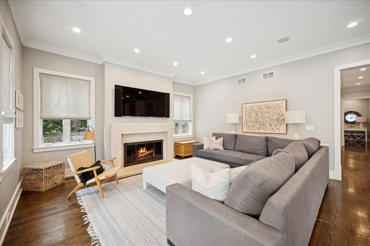 1004 Oak Street Winnetka, IL 60093 - Photo 20 of 51 a living room with furniture a fireplace and a flat screen tv