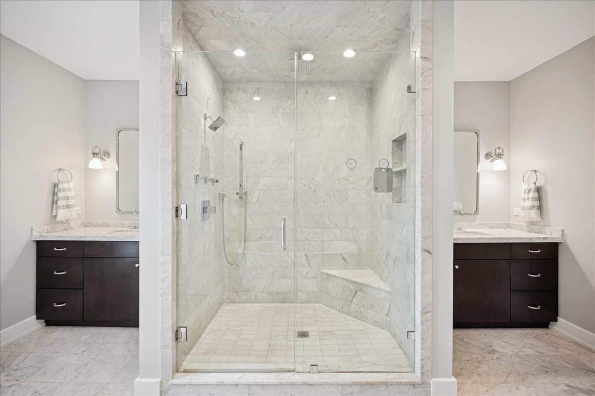 1004 Oak Street Winnetka, IL 60093 - Photo 26 of 51 a bathroom with a shower a sink and a mirror