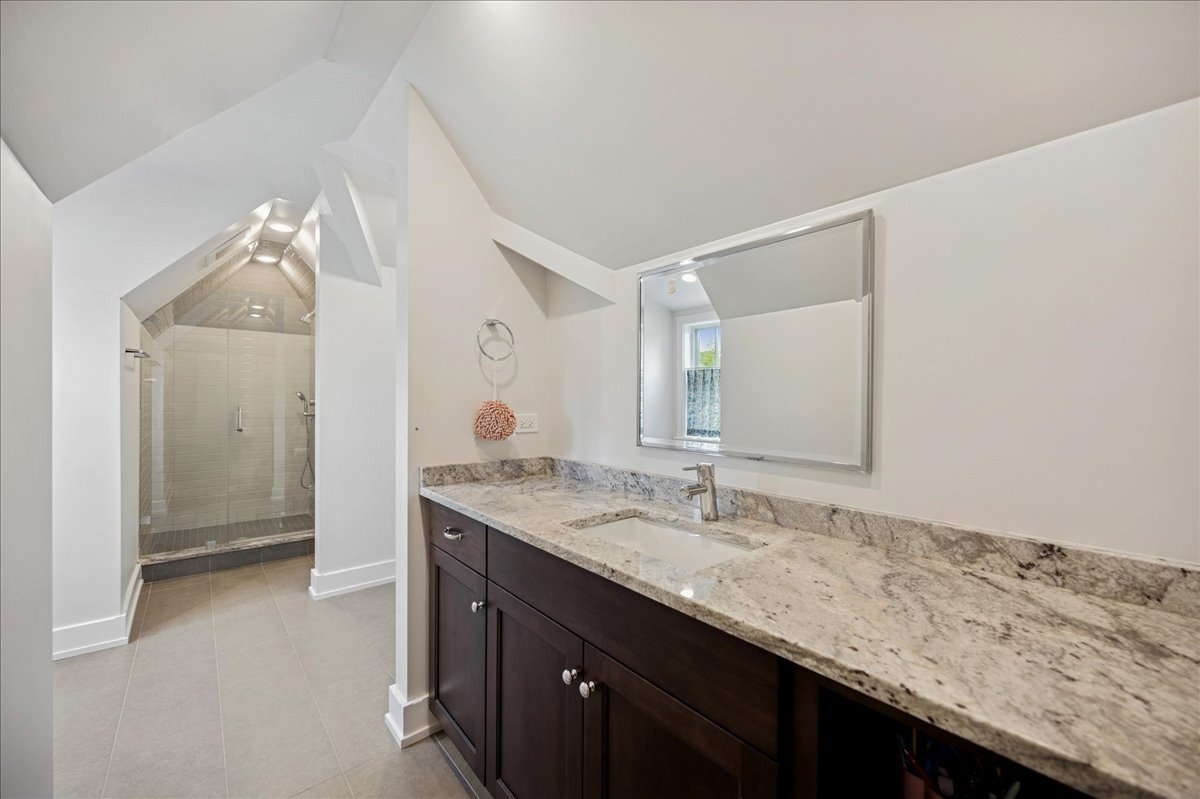 1004 Oak Street Winnetka, IL 60093 - Photo 36 of 51 a bathroom with a granite countertop sink and a mirror