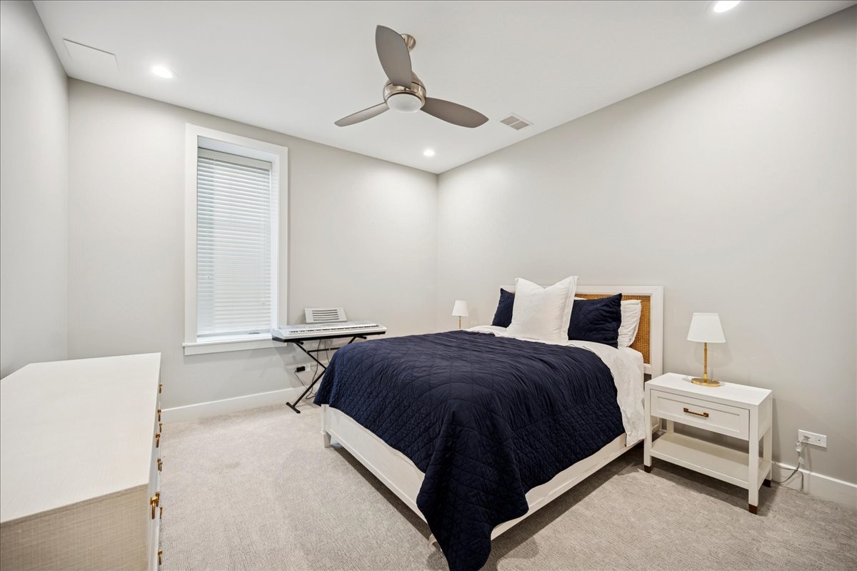 1004 Oak Street Winnetka, IL 60093 - Photo 41 of 51 a bedroom with a bed and a ceiling fan