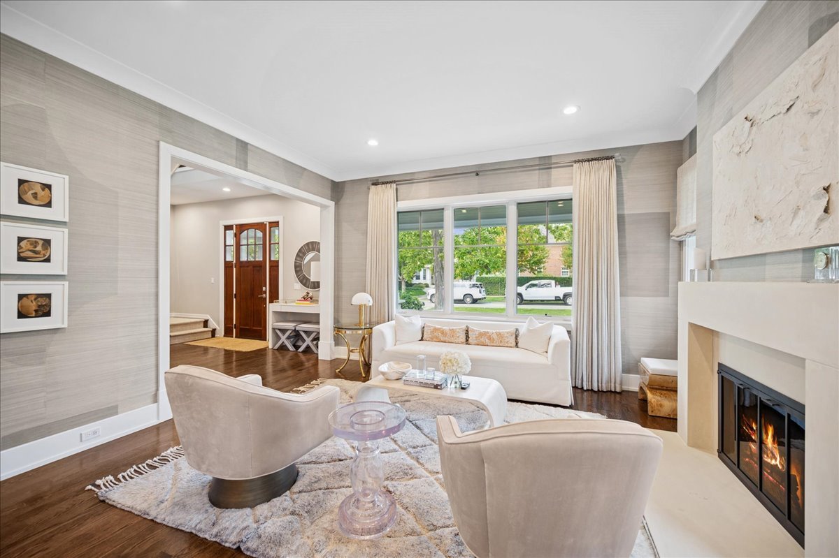 1004 Oak Street Winnetka, IL 60093 - Photo 8 of 51 a living room with furniture a fireplace and a large window