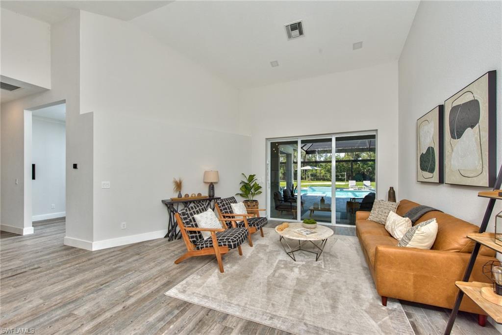 6106 Copper Leaf Lane Naples, FL 34116 - Photo 12 of 35 a living room with furniture and a large window