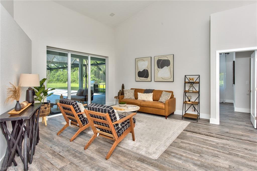 6106 Copper Leaf Lane Naples, FL 34116 - Photo 13 of 35 a living room with furniture and a window