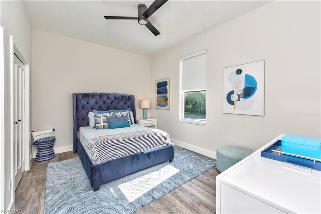 6106 Copper Leaf Lane Naples, FL 34116 - Photo 18 of 35 a bedroom with a bed and a painting on the wall