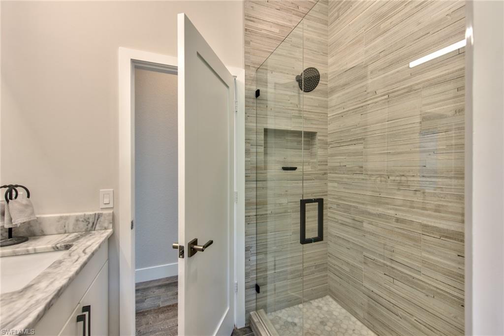 6106 Copper Leaf Lane Naples, FL 34116 - Photo 19 of 35 a bathroom with a shower