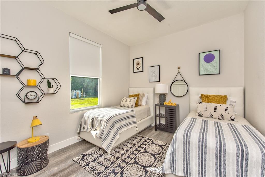 6106 Copper Leaf Lane Naples, FL 34116 - Photo 20 of 35 a bedroom with bed and a window