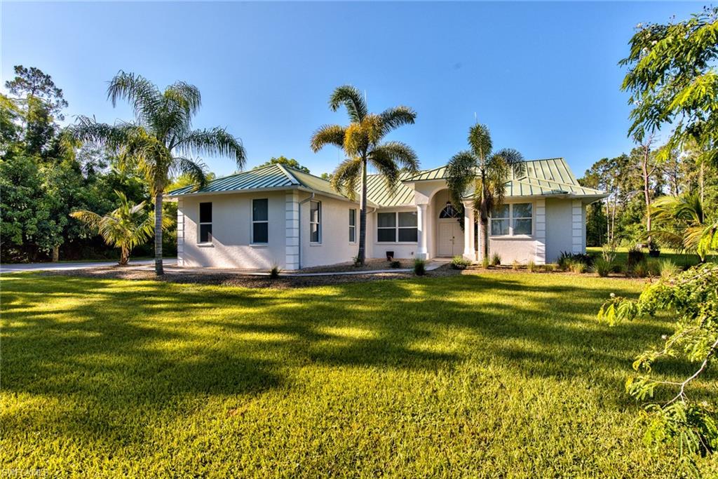 6106 Copper Leaf Lane Naples, FL 34116 - Photo 2 of 35 a front view of a house with swimming pool
