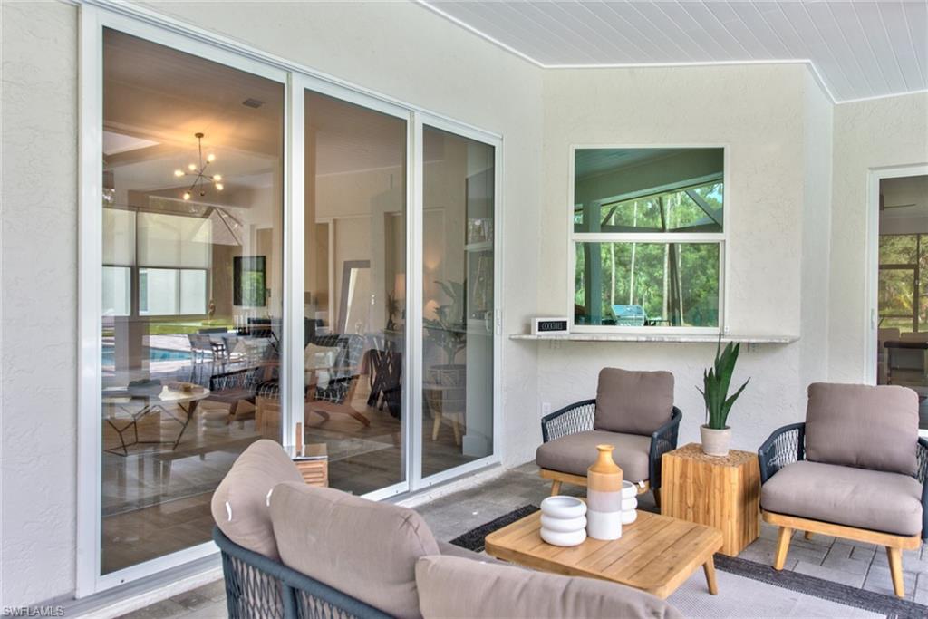 6106 Copper Leaf Lane Naples, FL 34116 - Photo 24 of 35 a living room with furniture and a large window