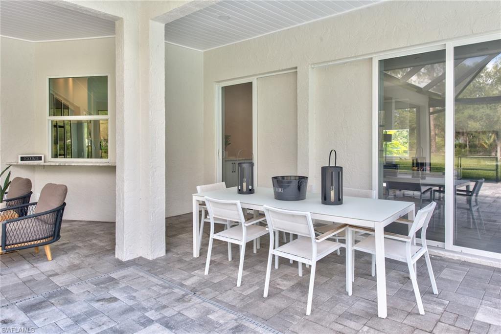 6106 Copper Leaf Lane Naples, FL 34116 - Photo 25 of 35 a view of a dining room with furniture window and outside view
