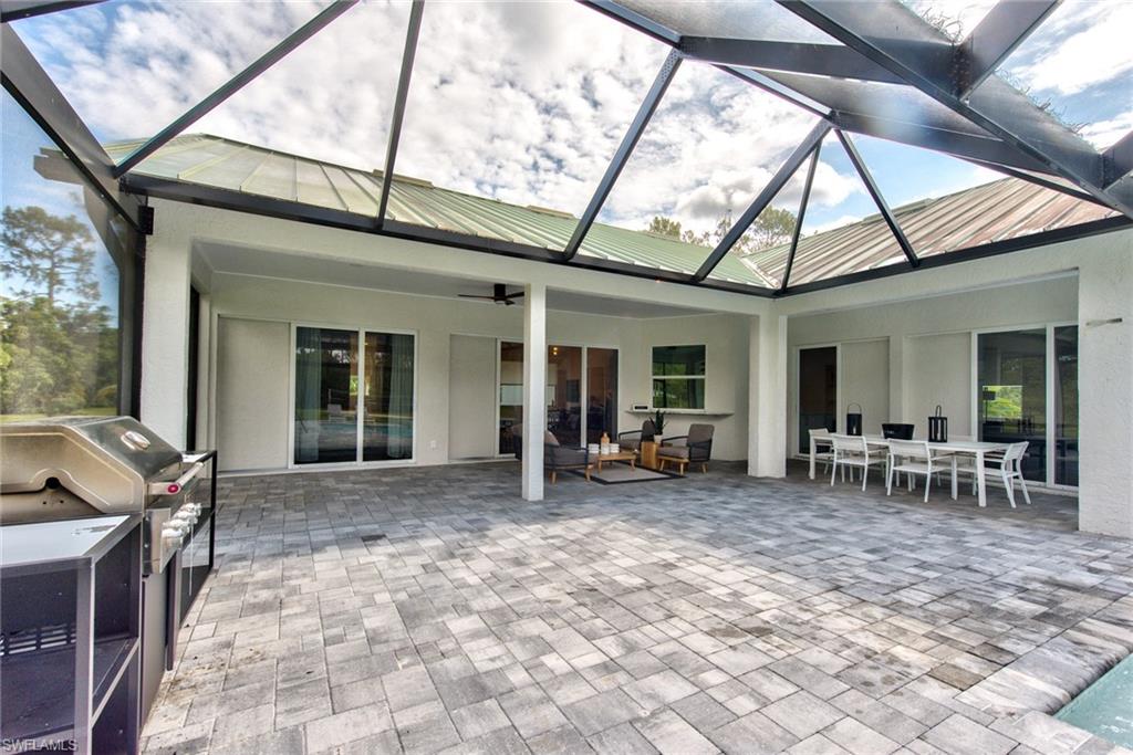 6106 Copper Leaf Lane Naples, FL 34116 - Photo 26 of 35 a view of house with outdoor seating space and barbeque oven