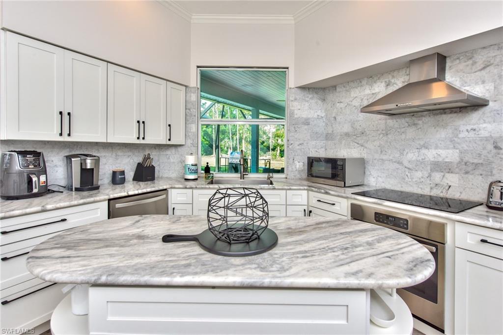 6106 Copper Leaf Lane Naples, FL 34116 - Photo 3 of 35 a kitchen with a stove a sink and a refrigerator