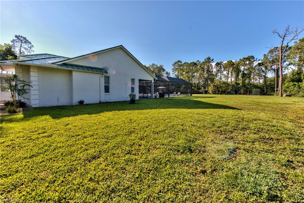 6106 Copper Leaf Lane Naples, FL 34116 - Photo 33 of 35 a house view with a garden space