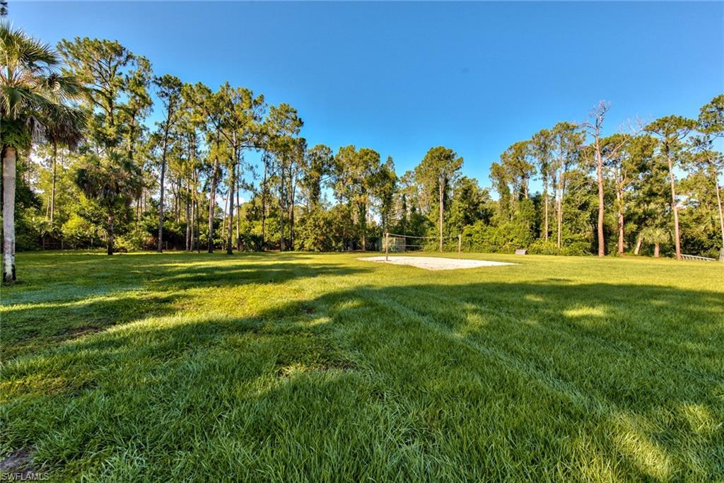 6106 Copper Leaf Lane Naples, FL 34116 - Photo 34 of 35 a view of grassy field with benches