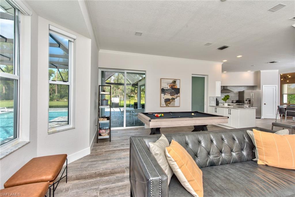 6106 Copper Leaf Lane Naples, FL 34116 - Photo 10 of 35 a living room with furniture wooden floor and a table