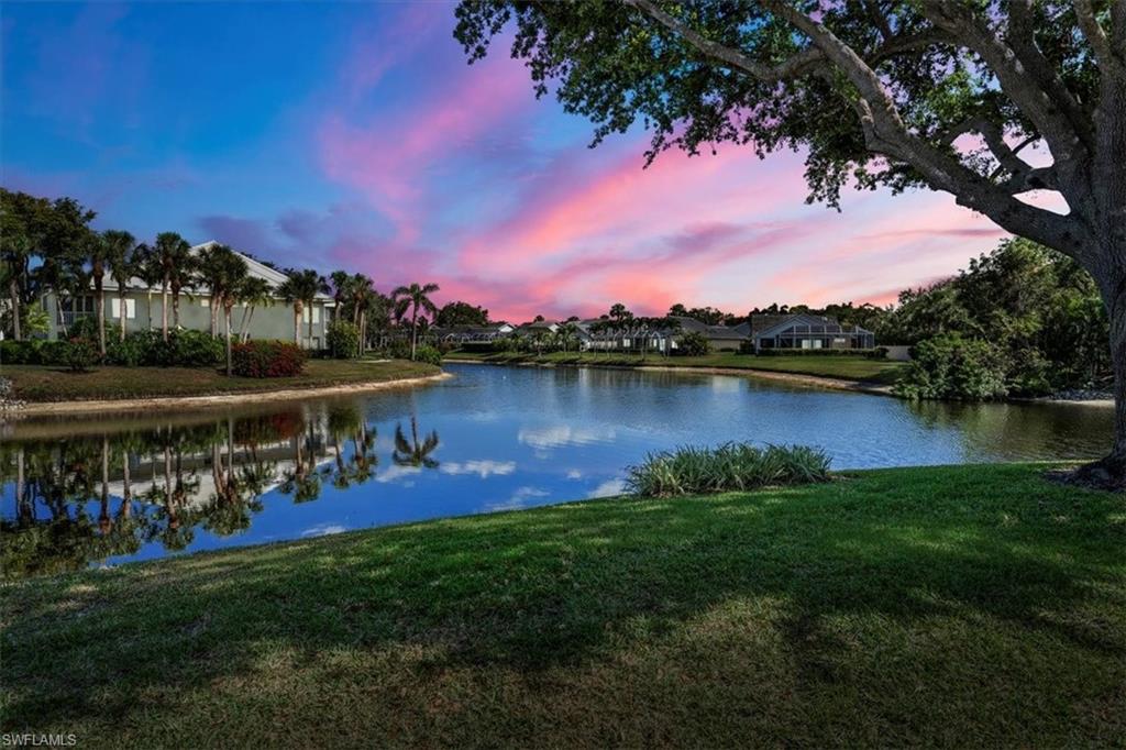 760 Willowbrook Drive, Unit 1204 Naples, FL 34108 - Photo 1 of 25 a view of a lake with houses in the back