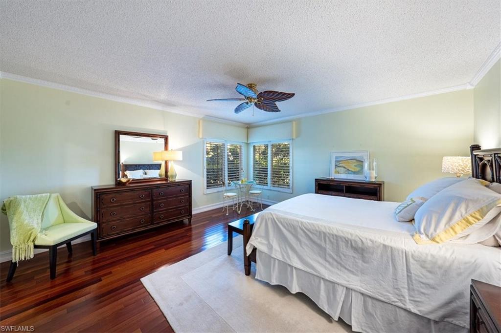 760 Willowbrook Drive, Unit 1204 Naples, FL 34108 - Photo 12 of 25 a bedroom with a bed and a dresser in it