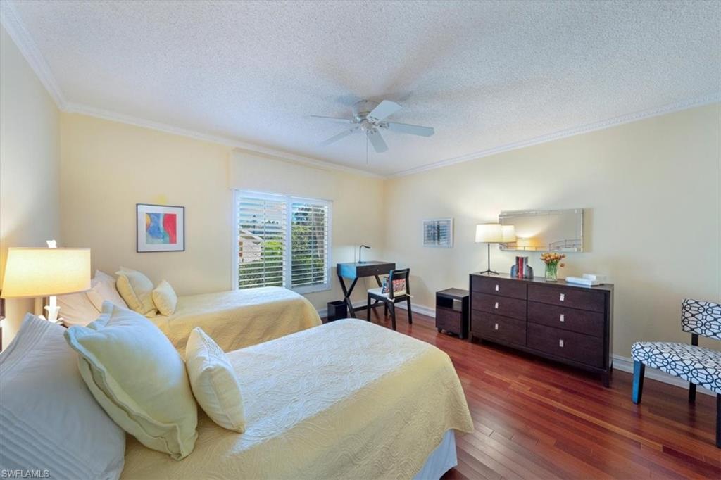 760 Willowbrook Drive, Unit 1204 Naples, FL 34108 - Photo 16 of 25 a bed room with a bed and a furniture