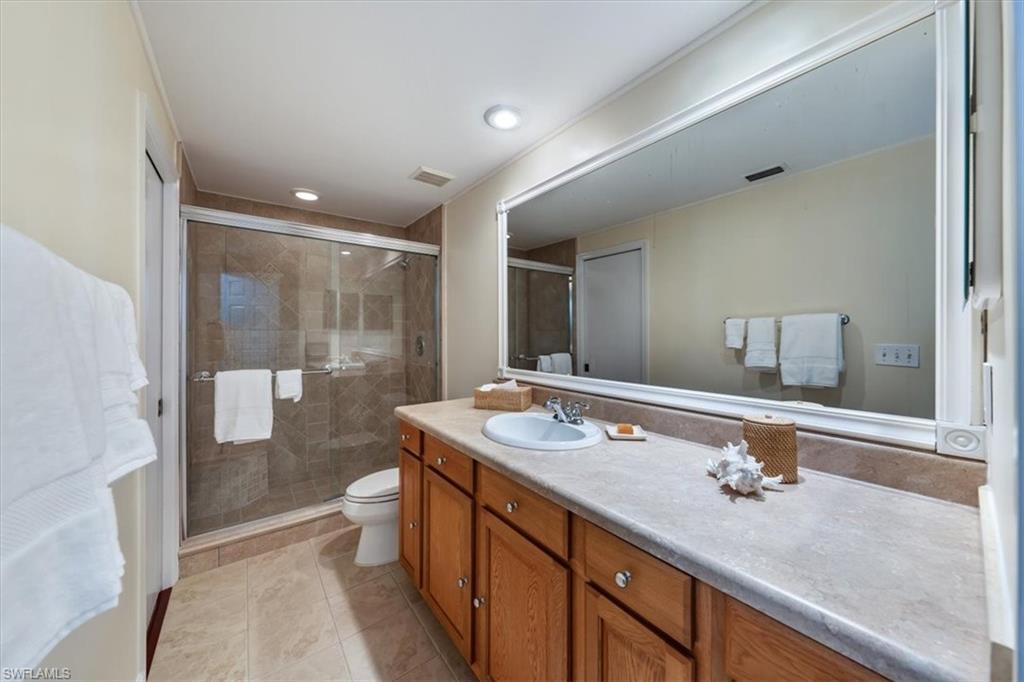 760 Willowbrook Drive, Unit 1204 Naples, FL 34108 - Photo 18 of 25 a bathroom with a sink and a mirror