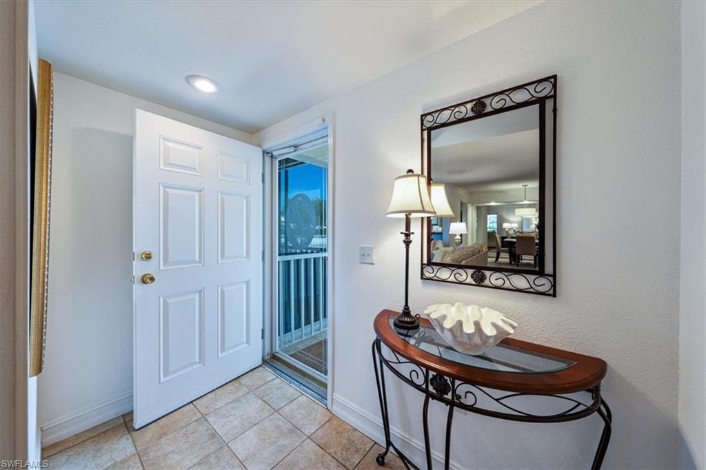 760 Willowbrook Drive, Unit 1204 Naples, FL 34108 - Photo 20 of 25 a dining room with furniture and a mirror