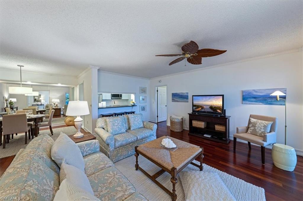 760 Willowbrook Drive, Unit 1204 Naples, FL 34108 - Photo 2 of 25 a living room with furniture and a flat screen tv