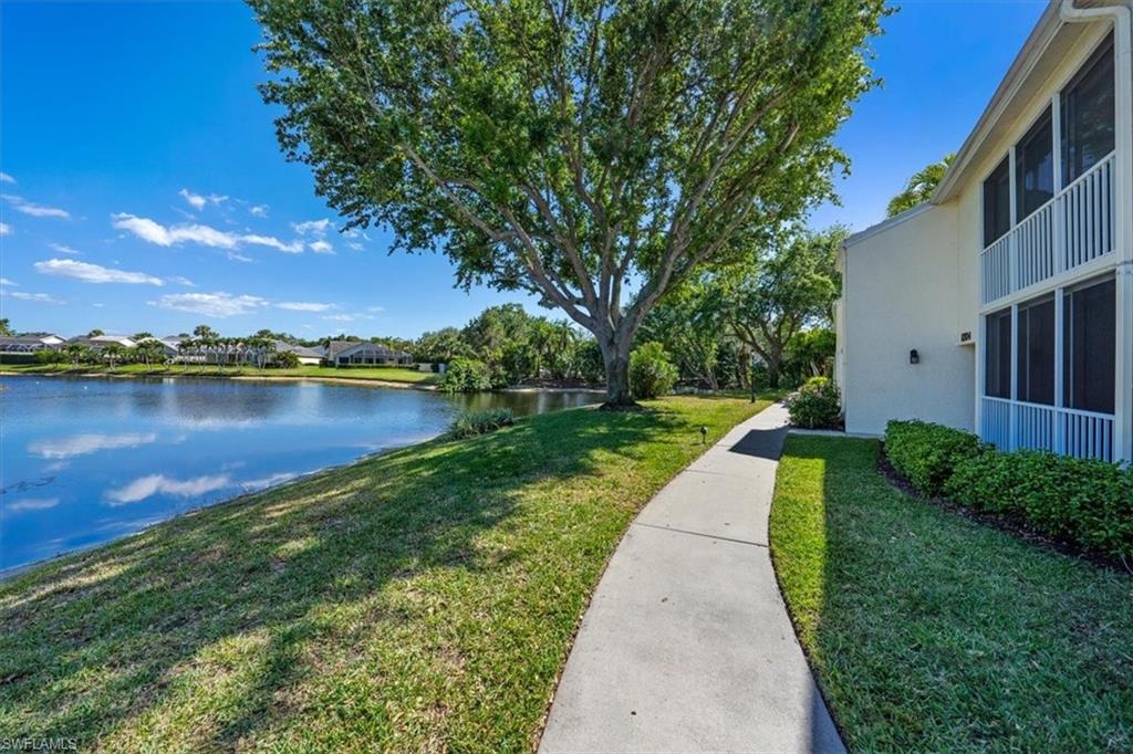 760 Willowbrook Drive, Unit 1204 Naples, FL 34108 - Photo 21 of 25 a view of a lake with houses in the back